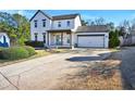 Attractive two-story home with attached garage, covered front porch, and a spacious driveway at 5065 Timberbridge Ln, Johns Creek, GA 30022