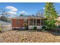 Brick home's backyard featuring a screened in porch, ideal for outdoor relaxation at 853 Erin Sw Ave, Atlanta, GA 30310