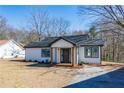 Newly renovated home with fresh exterior paint, and a inviting porch at 8176 Camp St, Douglasville, GA 30134