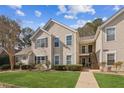 Attractive townhome with well-kept lawn and inviting stairway to the front door at 404 Ridgefield Dr, Peachtree City, GA 30269