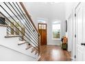 Bright entry way featuring hardwood floors, a staircase with modern railing and bench seating at 4834 Neal Rdg, Atlanta, GA 30349