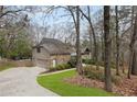 Lovely home featuring stone accents, a side-entry garage, and beautiful landscaping at 870 Waddington Ct, Atlanta, GA 30350