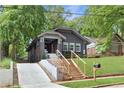 Charming home with a concrete driveway leading up to a beautifully landscaped front yard and inviting entrance at 994 Byron Sw Dr, Atlanta, GA 30310
