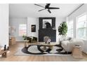 Bright living room featuring modern furniture, a black brick fireplace, and ample natural light at 994 Byron Sw Dr, Atlanta, GA 30310
