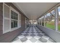 View of the long screened-in porch with a black and white checkered floor at 2880 Hall Se Dr, Smyrna, GA 30082