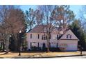 Elegant two-story house with a well-maintained lawn and classic architectural details at 505 Tilbury Dr, Suwanee, GA 30024