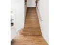 Beautiful staircase with light wood treads, a white handrail, and a minimalist design at 1563 Westwood Sw Ave, Atlanta, GA 30310