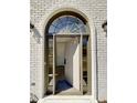 Elegant front entrance with arched window above the door, allowing natural light into the foyer at 3850 Westwick Nw Way, Kennesaw, GA 30152