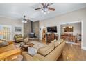 Warm living room boasts a striking stone fireplace, hardwood floors, and an open layout into dining area at 3890 Irwin Bridge Nw Rd, Conyers, GA 30012