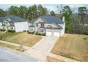 Aerial view of a two-story home and driveway, showing the manicured lawn and surrounding neighborhood landscape at 4526 Warren Mill Trl, Ellenwood, GA 30294