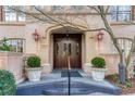 Elegant building entryway with stone archway, decorative planters, and dark wood double doors exudes upscale charm at 1717 N Decatur Ne Rd # 322, Atlanta, GA 30307