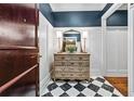 Stylish hallway featuring checkerboard tile flooring, decorative chest, and attractive wall decor at 1717 N Decatur Ne Rd # 322, Atlanta, GA 30307