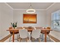 Bright dining room featuring a modern light fixture and a large window with natural light at 213 Augusta Walk, Canton, GA 30114