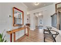 Inviting foyer with hardwood floors, decorative table, and a view of the staircase and front door at 213 Augusta Walk, Canton, GA 30114