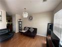 Cozy living room with wood floors and a decorative chandelier at 6231 Hickory Lane Cir, Union City, GA 30291