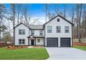 Charming two-story white home with a two-car garage and manicured front yard at 4352 Riverlake Way, Snellville, GA 30039