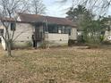 Back exterior view of the house with a ladder leaning against the exterior at 8482 Fairview Dr, Douglasville, GA 30134