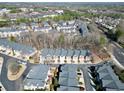 Aerial view of a residential community with tree-lined streets and well-maintained townhomes at 2349 Harshaw Ave, Lawrenceville, GA 30043