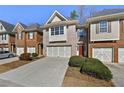 Charming townhome featuring a brick facade, a two-car garage, and a well-maintained lawn at 2349 Harshaw Ave, Lawrenceville, GA 30043