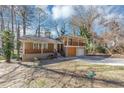 View of split-level home with a front porch, upper level balcony, attached garage and a nice yard at 389 Harlan Sw Rd, Atlanta, GA 30311
