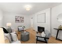 Bright living room features a fireplace, hardwood floors, and neutral decor at 1428 Pinehurst Sw Dr, Atlanta, GA 30311