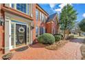 Elegant front entrance with a brick walkway and manicured greenery at 1558 Amberwood Creek Nw Dr, Kennesaw, GA 30152