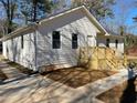 Charming single-story home with new white siding, black roof, and a wood porch at 5385 Booker T Dr, Morrow, GA 30260