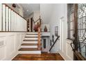 Inviting foyer with hardwood floors, elegant staircase, decorative accents, and beautiful glass front door at 2348 Loraine Ne St, Atlanta, GA 30319