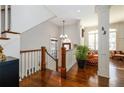 Upstairs landing with hardwood floors, beautiful railing, natural light, and elegant chandelier at 2348 Loraine Ne St, Atlanta, GA 30319