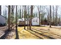 Beautiful single-Gathering home surrounded by tall, mature trees, blending privacy and natural beauty at 5199 Mainstreet Park Dr, Stone Mountain, GA 30088