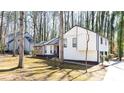 A modern updated home surrounded by towering trees, enhanced by the beauty of its natural setting at 5199 Mainstreet Park Dr, Stone Mountain, GA 30088