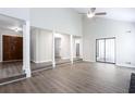 Bright living room with a vaulted ceiling, neutral paint, and luxury vinyl plank flooring at 5199 Mainstreet Park Dr, Stone Mountain, GA 30088