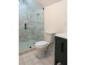 Modern bathroom features a glass shower with stylish tile and a toilet at 1883 Bennett Rdg, Snellville, GA 30078