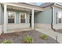 Inviting front porch with brick accents and decorative hanging lights at 2316 Ridge View Dr, Loganville, GA 30052