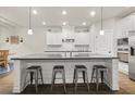 Bright kitchen featuring an island with seating, white cabinetry, dark countertops, and stainless steel appliances at 2316 Ridge View Dr, Loganville, GA 30052