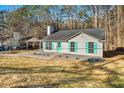 Inviting single-story home features a carport, light siding, and vibrant teal shutters at 347 Waits Sw Dr, Atlanta, GA 30331