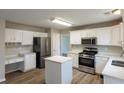 Modern kitchen featuring stainless steel appliances, an island, hardwood floors and plenty of counter space at 4060 Rockmill Cv, Ellenwood, GA 30294
