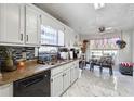 Bright eat-in kitchen with granite counters, white cabinets and stainless steel dishwasher at 760 Josh Ln, Lawrenceville, GA 30045