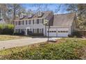 Attractive two-story home features a basketball hoop and a two-car garage, set against a lush lawn at 2077 Moccasin Sw Way, Marietta, GA 30064