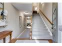 Inviting home entryway featuring a staircase with carpet and hardwood floors at 2421 Saint Davids Nw Sq, Kennesaw, GA 30152