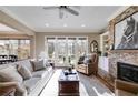 Bright living room with fireplace, built-ins, and doors leading to the outdoor space at 2421 Saint Davids Nw Sq, Kennesaw, GA 30152