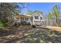 Inviting exterior with a welcoming front porch, complemented by mature trees, offering a tranquil setting at 306 Jacob Trl, Rockmart, GA 30153