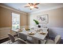Elegant dining room with a marble-topped table, stylish decor, and a large window at 3480 Buffington Ln, Cumming, GA 30040