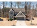 Inviting two-story home featuring a stone-accented garage and a neatly kept front yard at 3480 Buffington Ln, Cumming, GA 30040