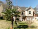 Two-story brick home with palm trees in the front yard and two-car garage at 6809 Ridgewood Ln, Riverdale, GA 30296
