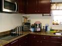 A well-equipped kitchen features granite countertops and dark wood cabinets at 6809 Ridgewood Ln, Riverdale, GA 30296