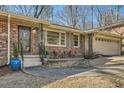 Inviting front entrance with a brick facade, stylish planters, and a cozy seating area at 4279 Castle Pines Ct, Tucker, GA 30084