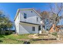 Two-story home featuring white siding, front stairs, and an unfinished front yard at 4821 Mainstreet Valley Trce, Stone Mountain, GA 30088