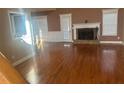 Spacious living room featuring hardwood floors and a stone fireplace at 9996 Village South Dr, Douglasville, GA 30135