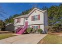 Side view of a charming two-story home with landscaped yard and a cozy, inviting atmosphere at 3420 Lineview Dr, Ellenwood, GA 30294